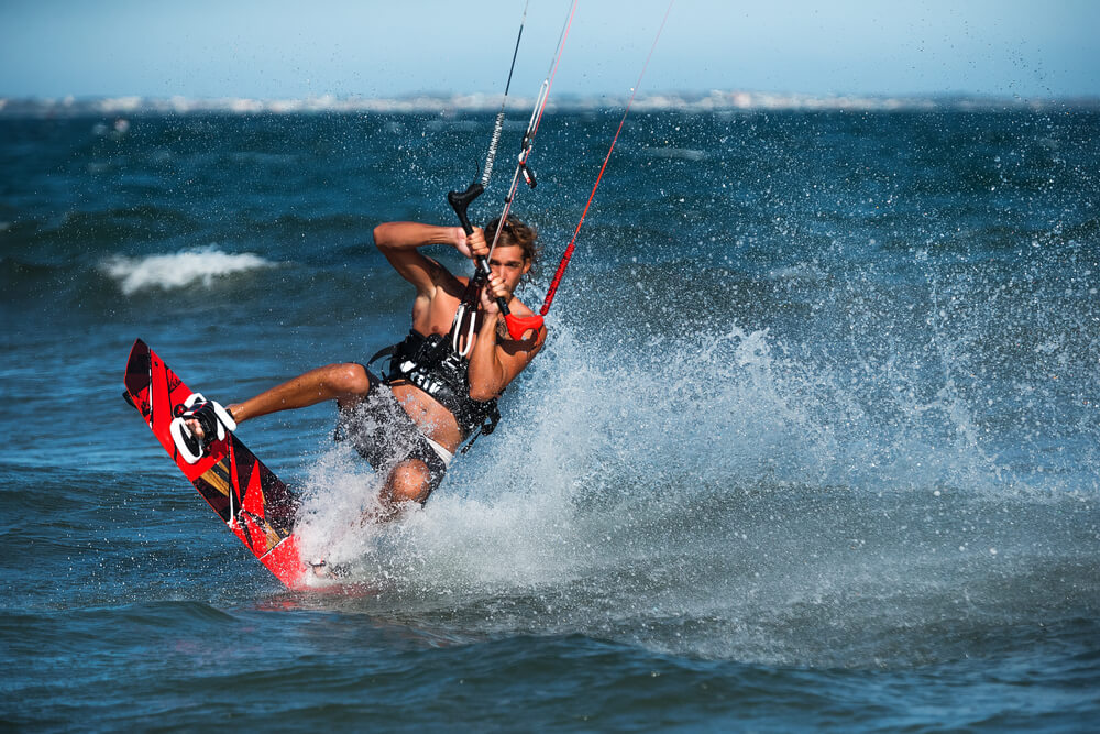 Kite surfer rides waves