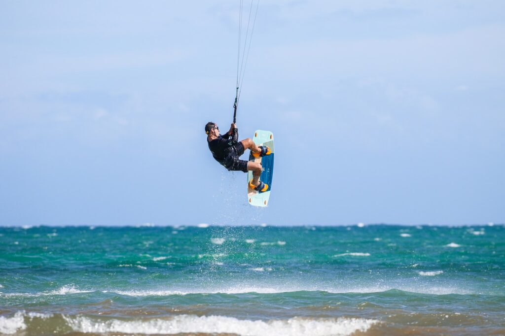 Man with Kiteboard Jumping the Sea Waves