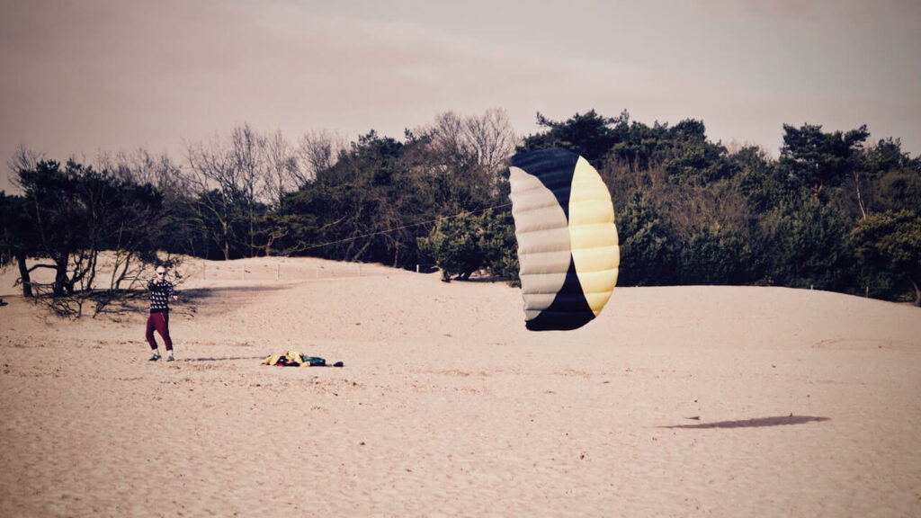 Person Holdign Black and Yellow Parachute